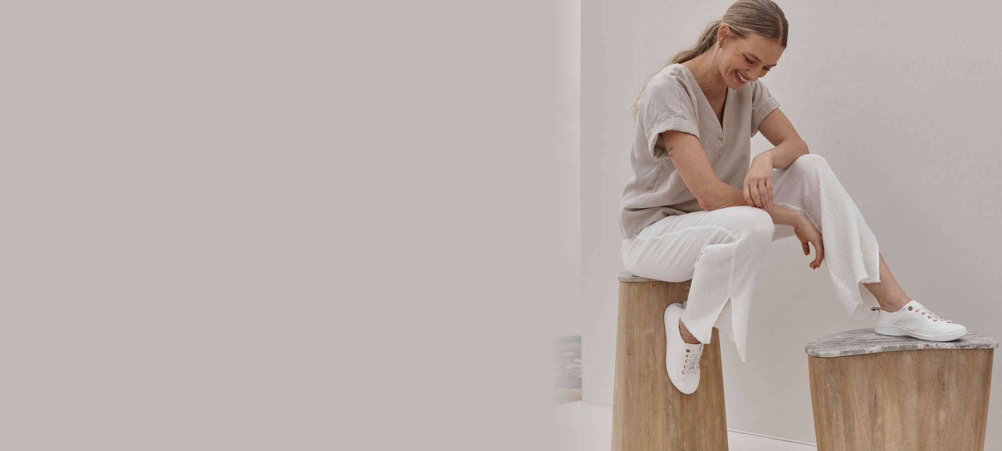 Woman wearing white Vionic sneakers in a neutral lifestyle setting